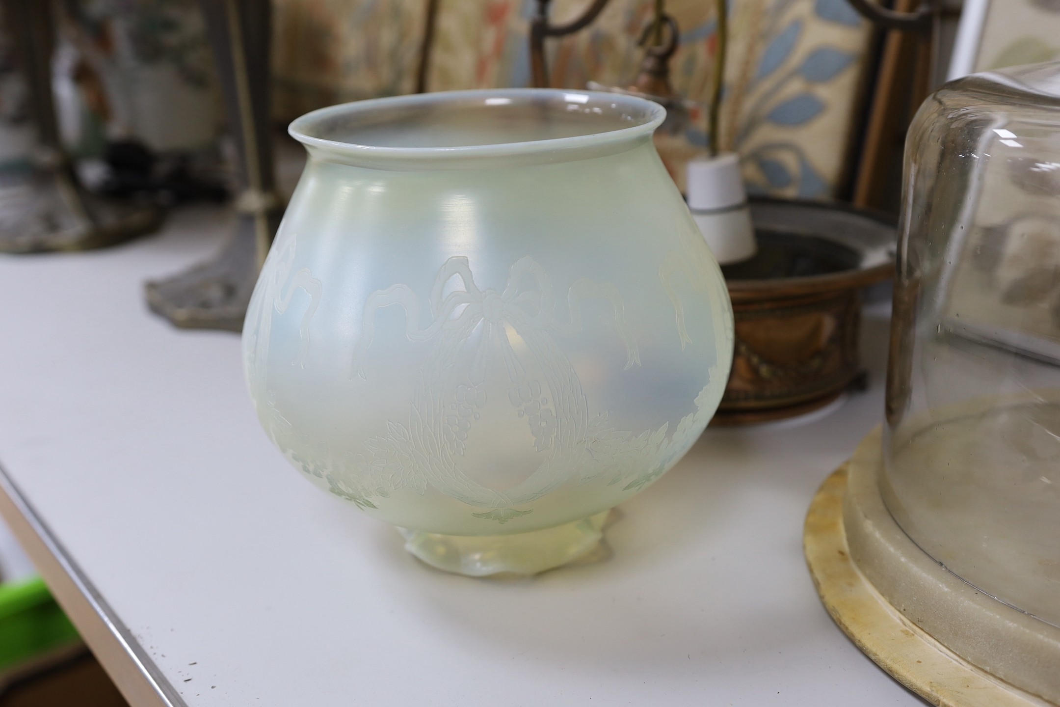 An embossed copper ceiling light with vaseline glass shade, and Far Famed Cake Co. cake stand and domed cover